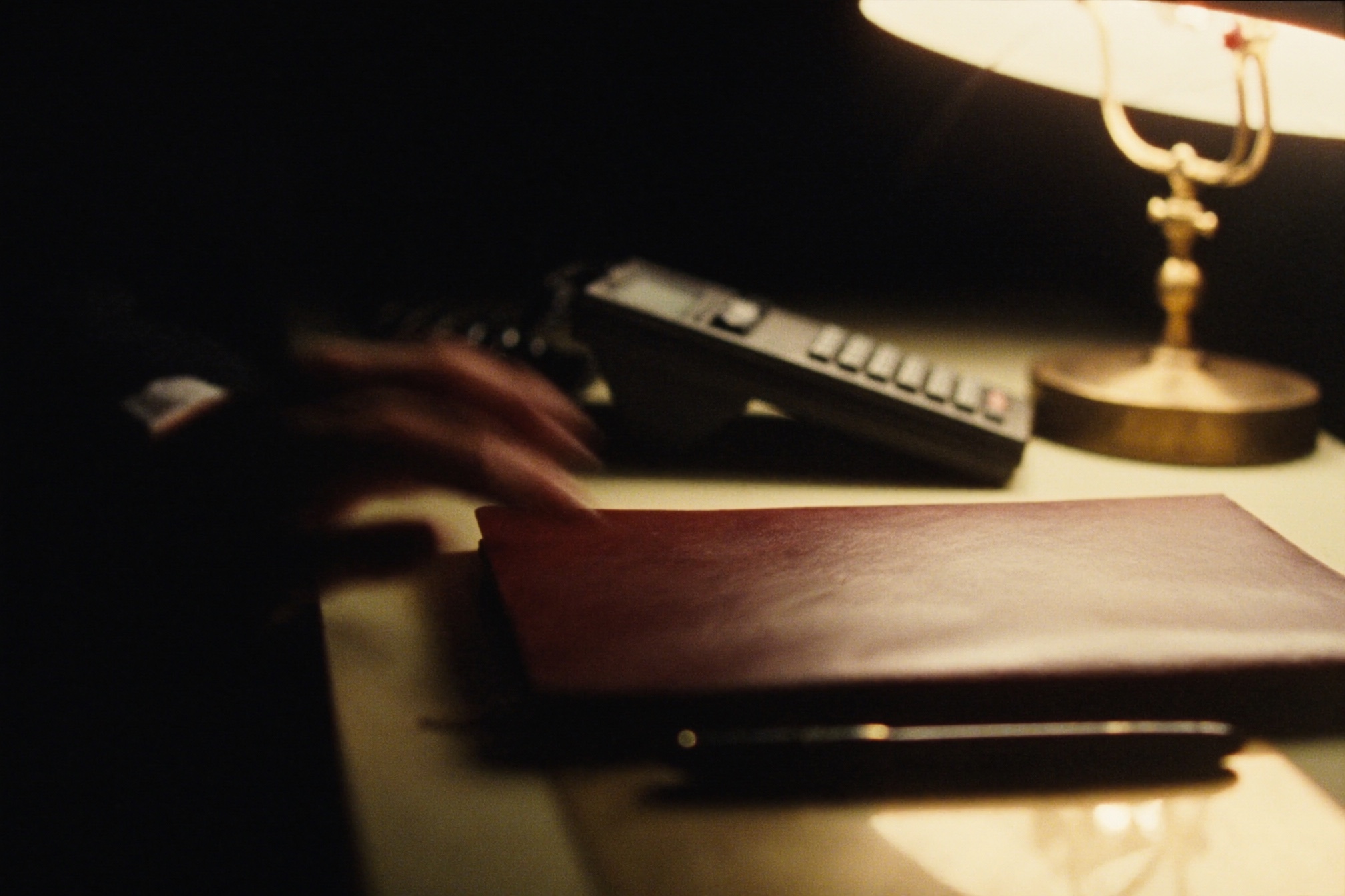 Concierge desk detail under a warm lamp