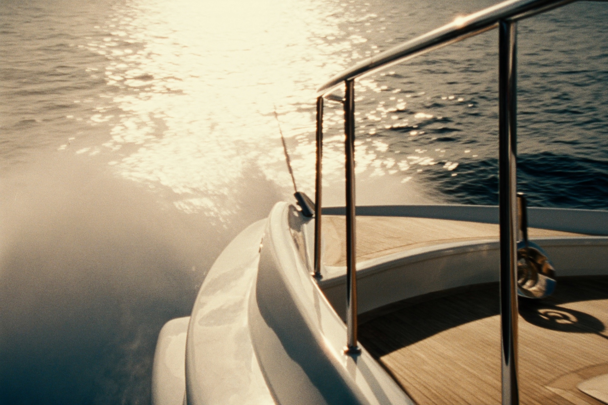 Bow of a superyacht cutting through Mediterranean water